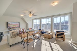 Carpeted upstairs entertainment room in Craig Builders home in Oak Hill Farm