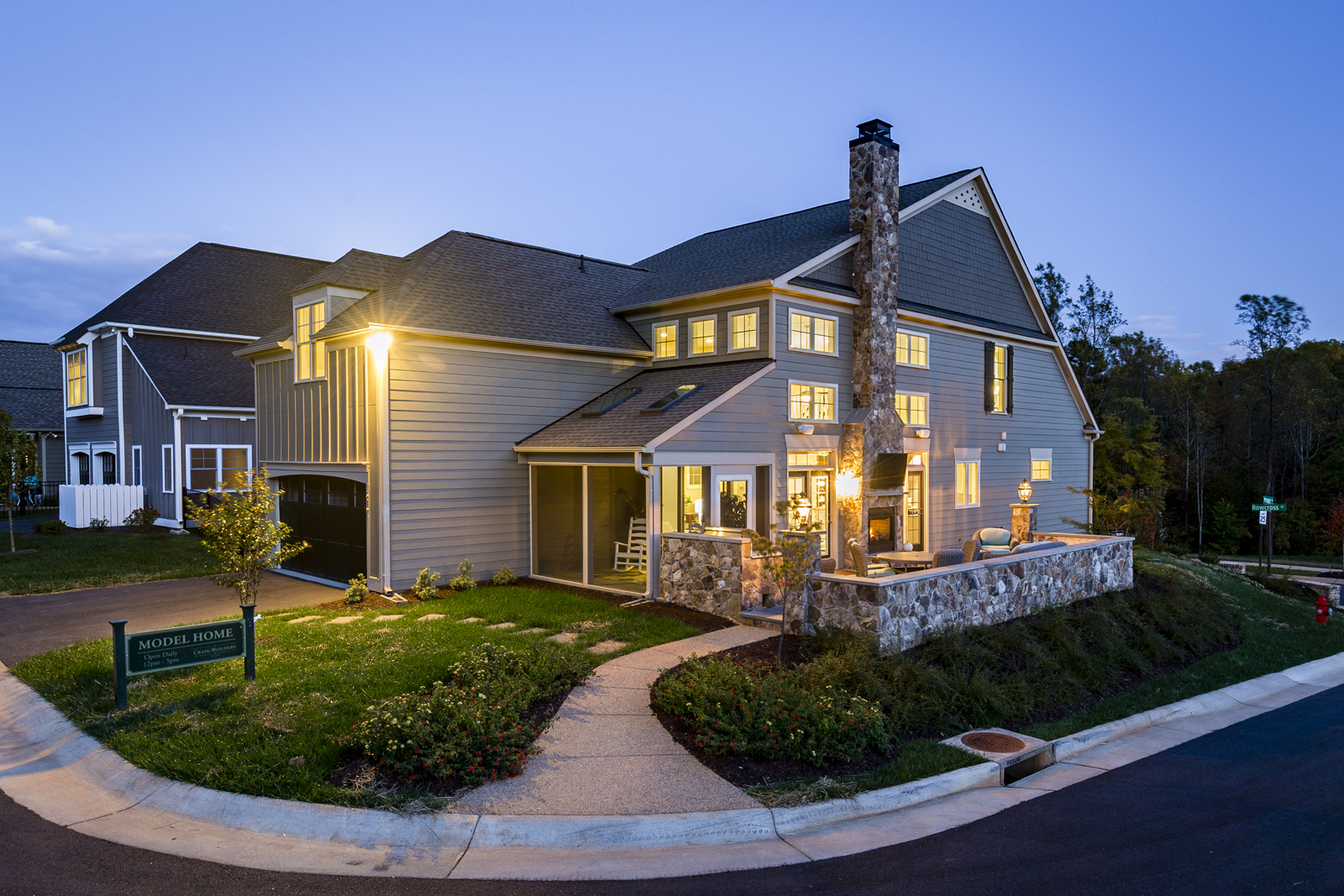 Exterior of Craig Builders model home in Old Trail Village in the evening.
