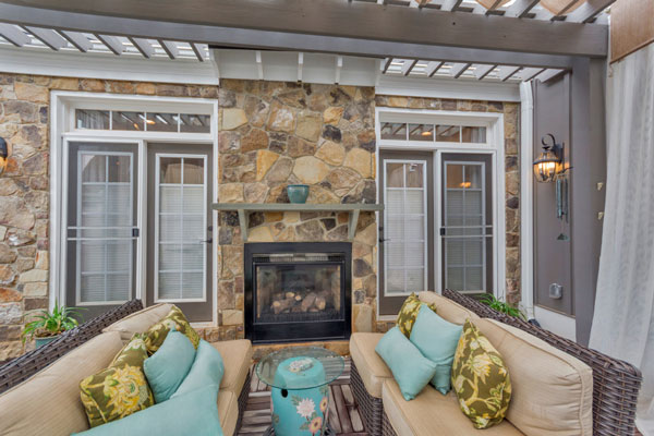 Beautiful Craig Builders patio on The Villager Courtyard home plan. Featuring an inside-outside fireplace.