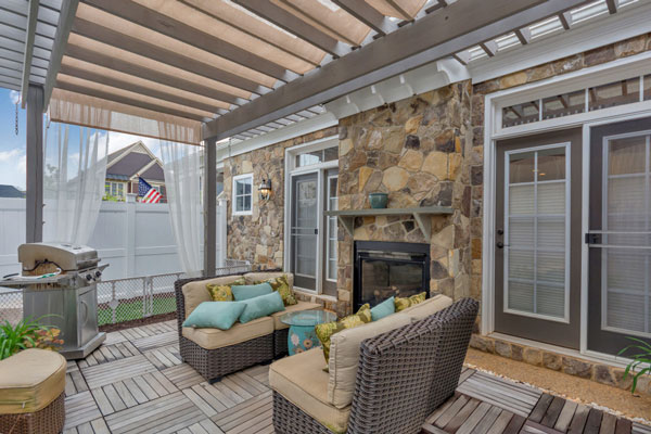 Beautiful Craig Builders patio on The Villager Courtyard home plan. Featuring an inside-outside fireplace.
