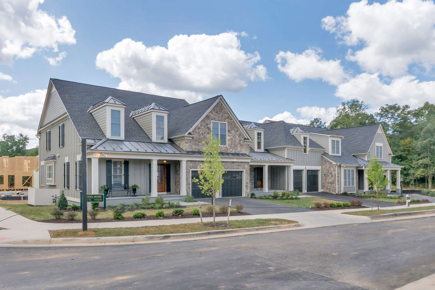Craig Builders New Homes In Charlottesville Virginia A Grey Sided Home With Small Front Porch And Double Doored Garage In Stone